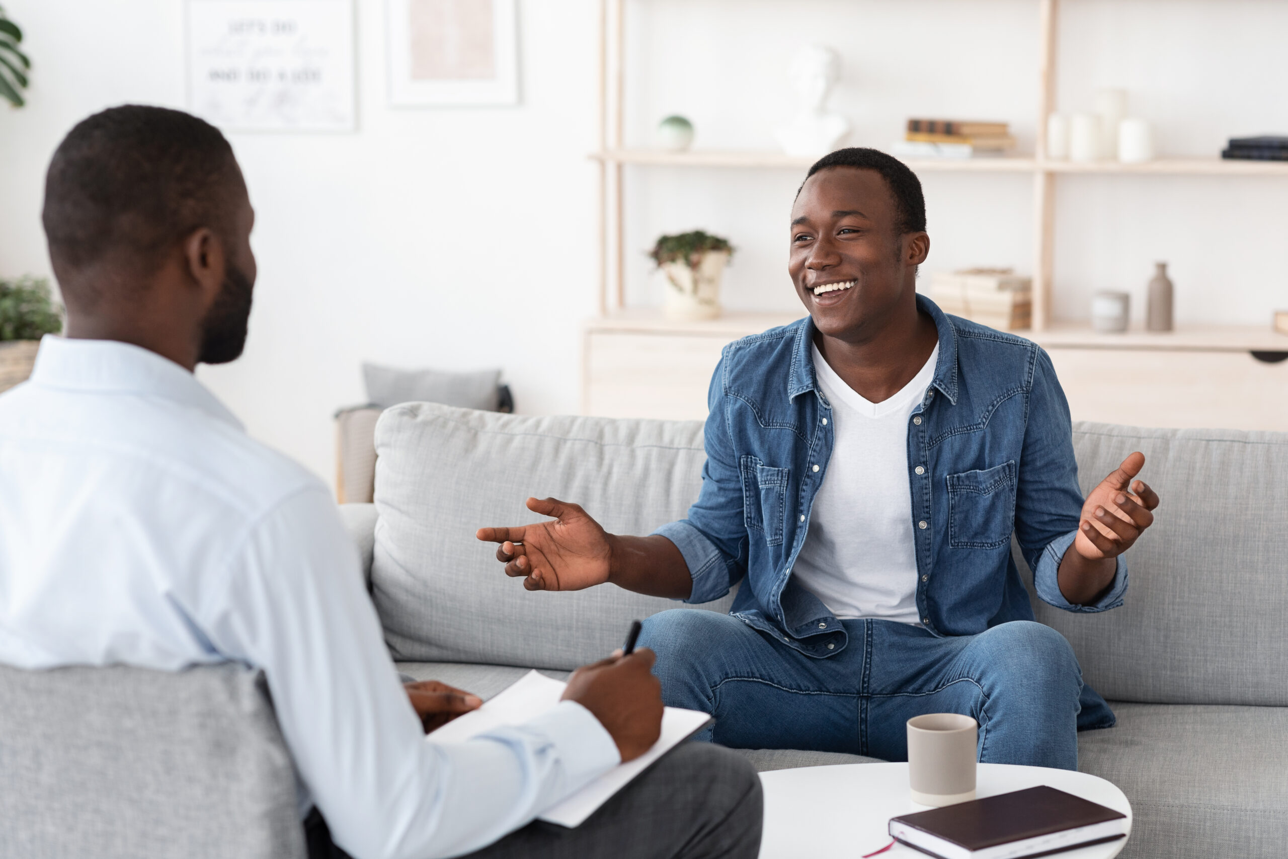 Successful therapy cheerful black man talking to psychologist on meeting